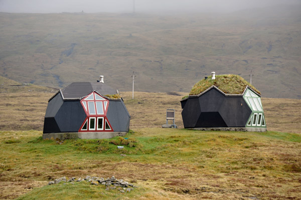 A pair of houses shaped like geodesic domes above the village of Kvvk
