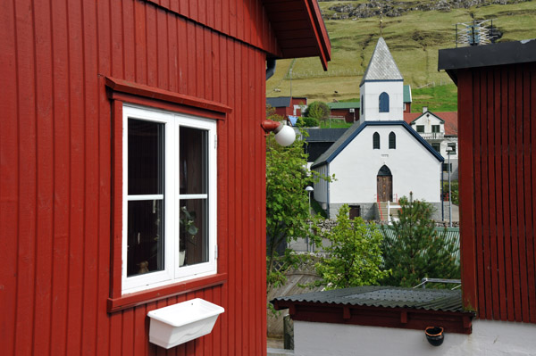Red house and the church of Kvvk, Faroe Islands