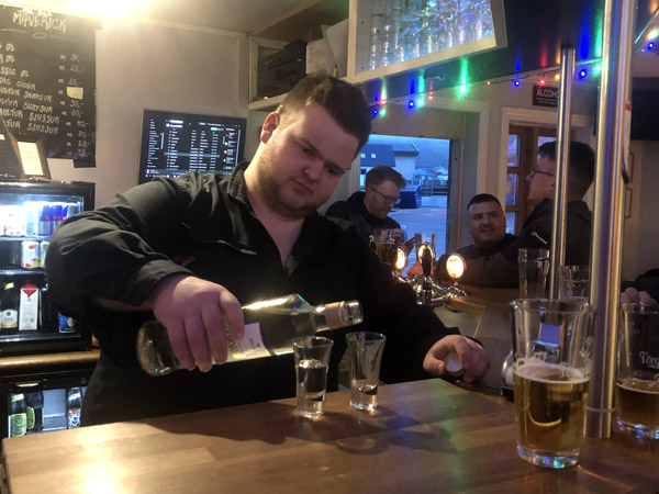 The Bartender at Maverik pouring the Akvavitt