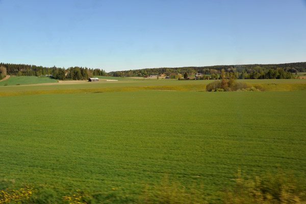 Green fields of southwest Finland from the train to Helsinki