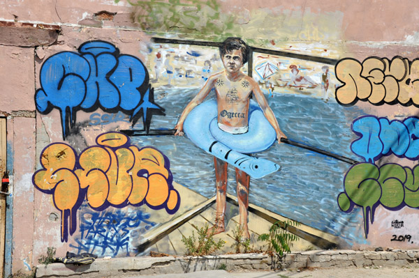 Graffiti mural of a boy at the beach, Odessa