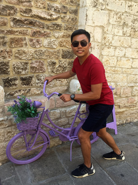 Max pushing the lavender bicycle