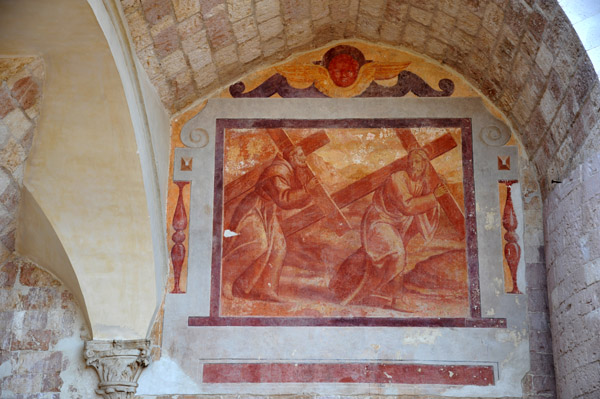 Fresco of St Francis following Jesus carrying crosses