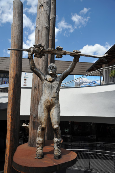 Life-sized wooden sculpture of a ski racer in the base station of the Alpe di Siusi cableway 