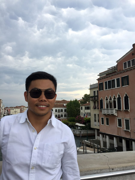 Max on a bridge in Venice with threatening clouds