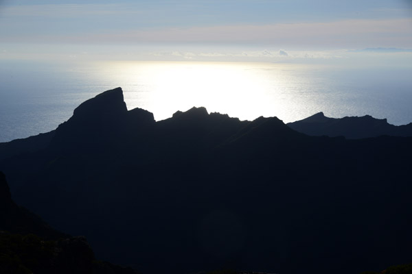 Late afternoon sun silhouetting a mountain ridge against the Atlantic
