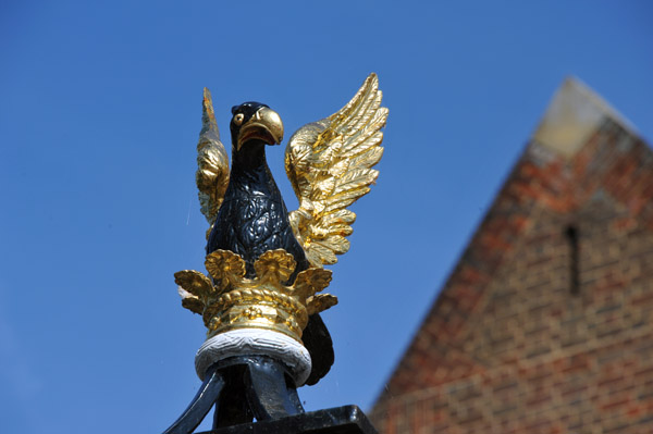 1575 Queens' College crest, out of a coronet or, an eagle rousant sable, wings or