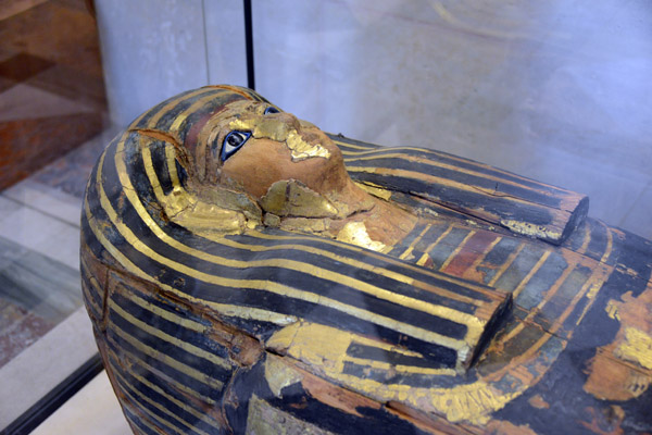 Wood sarcophagus with the gilded face mostly missing
