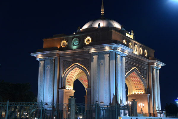 Monumental gateway to the Emirates Palace Hotel at night