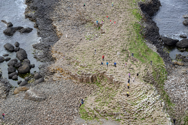Tiny tourists scrambling on the Giant's Causeway