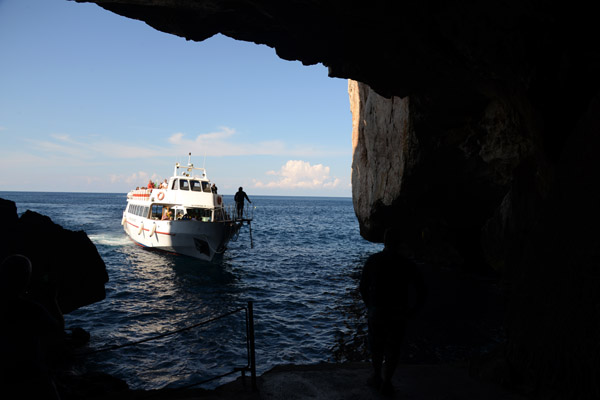 Tour boat entering the mouth of Neptune's Grotto to drop off a load of tourists