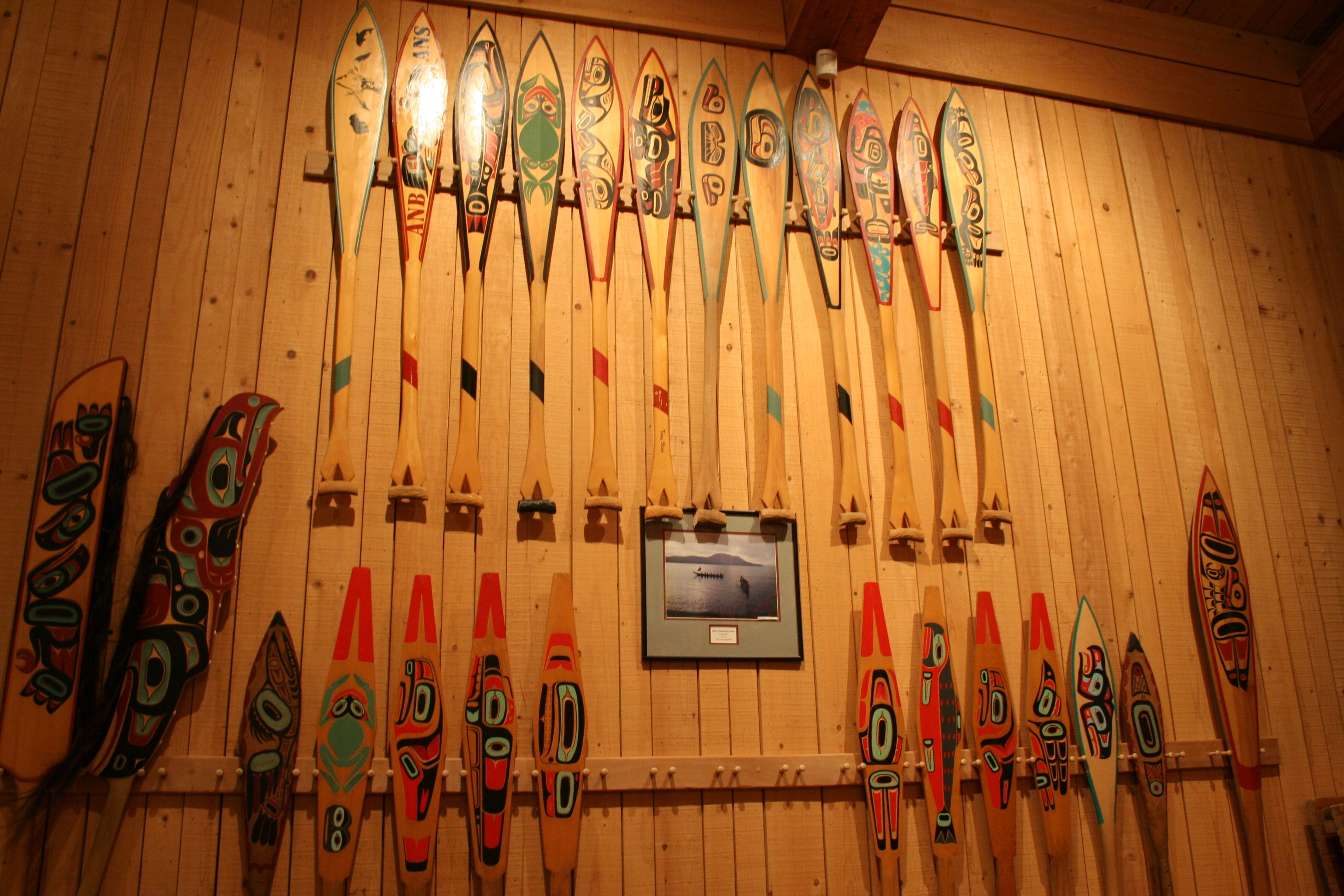 Traditional paddles displayed.