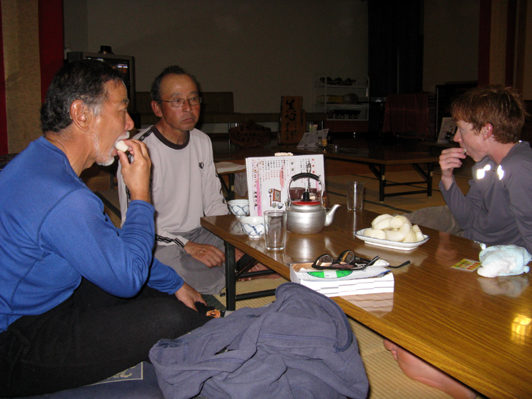 Relaxing after a hot onsen bath. Owner offers us some fruit.