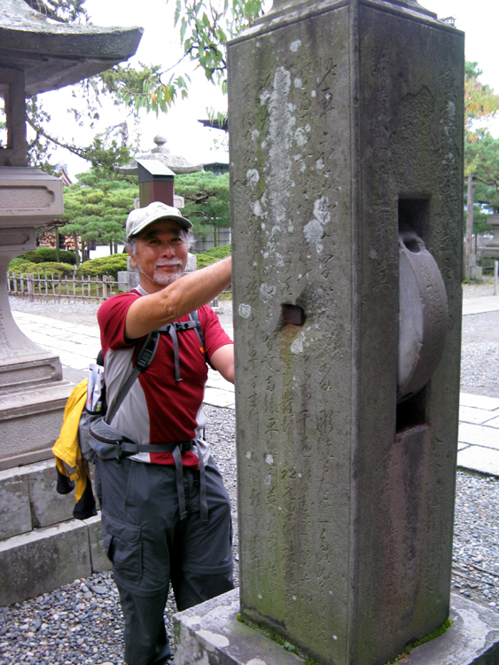 Geno turning the wheels of fortune at the Zenkoji Temple.