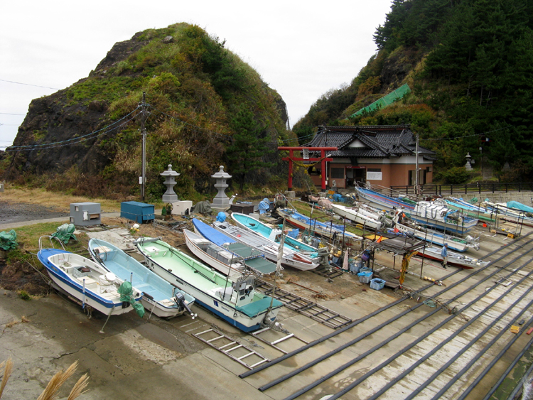 Fishing boats off the rock formation.