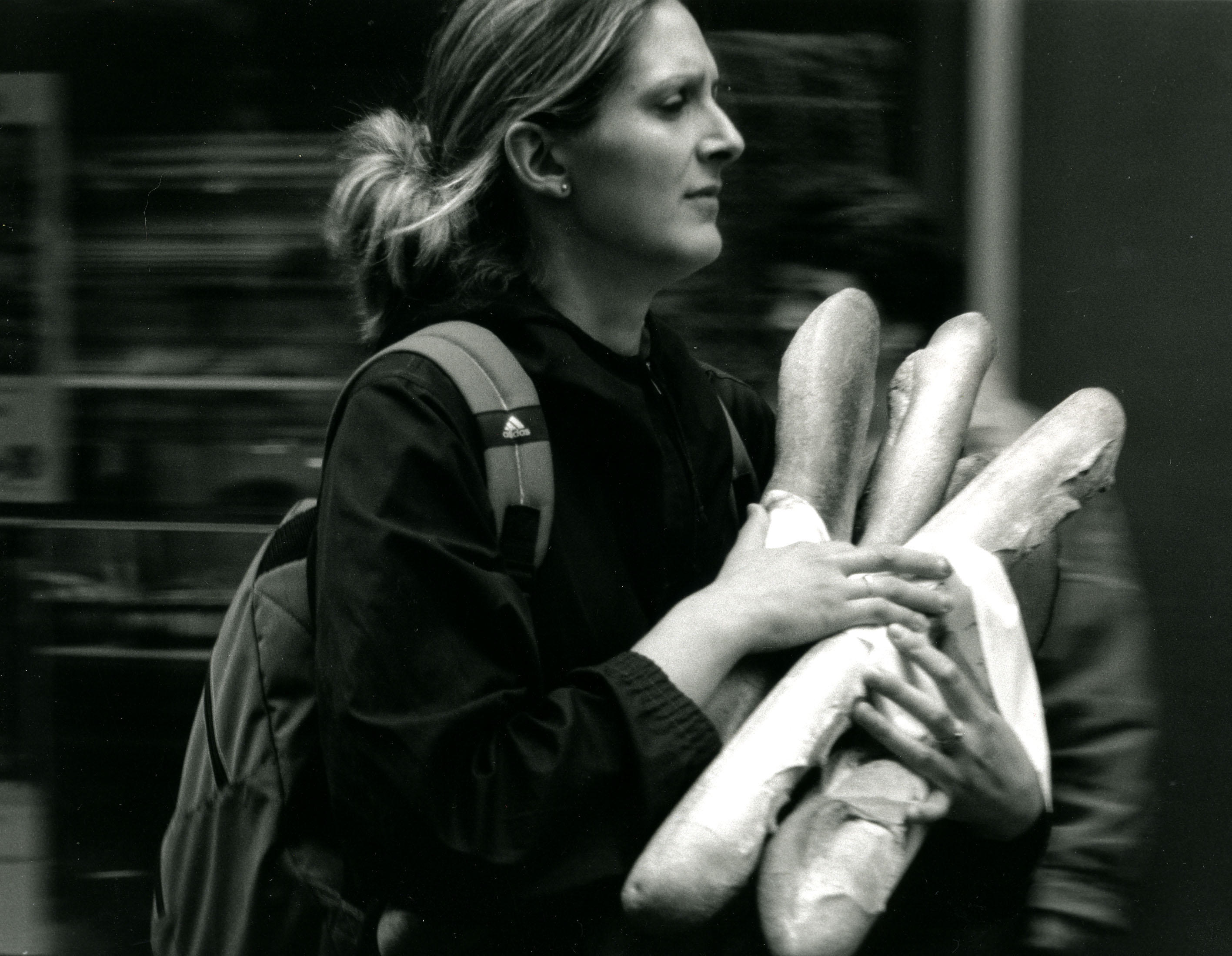 French Woman Carrying Bread, France 2005