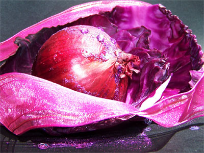 6 
Picture of onion, cabbage leaf and glittery ribbon taken in bright sunlight against a black sheet of paper. I glued some glitter and sequins to the onion.

Mrs. Potatohead is now suing me, because apparently I'm responsible for Mr. Potatohead running off with the onion. Maybe I should introduce her to a nice rutabaga...