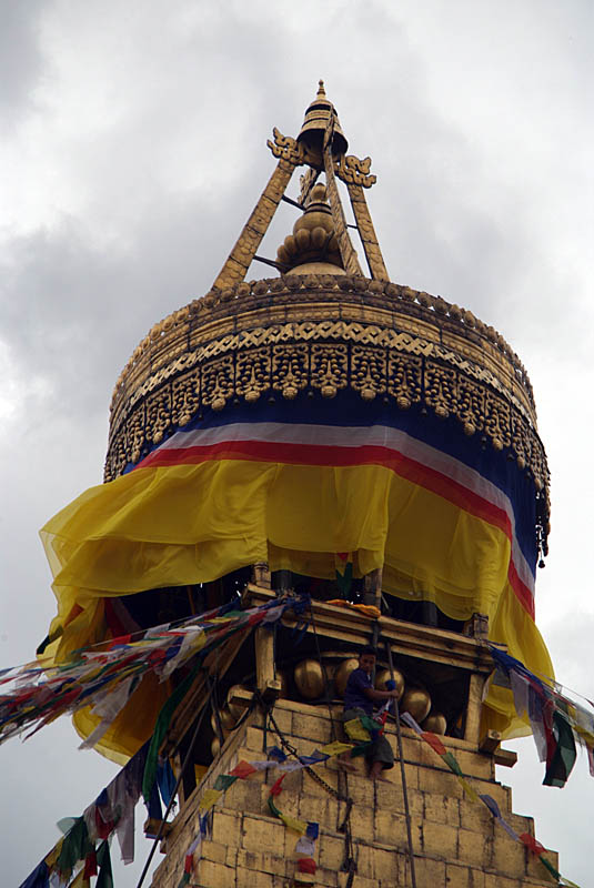 Man Replacing Prayer Flags in Boudha Stupa