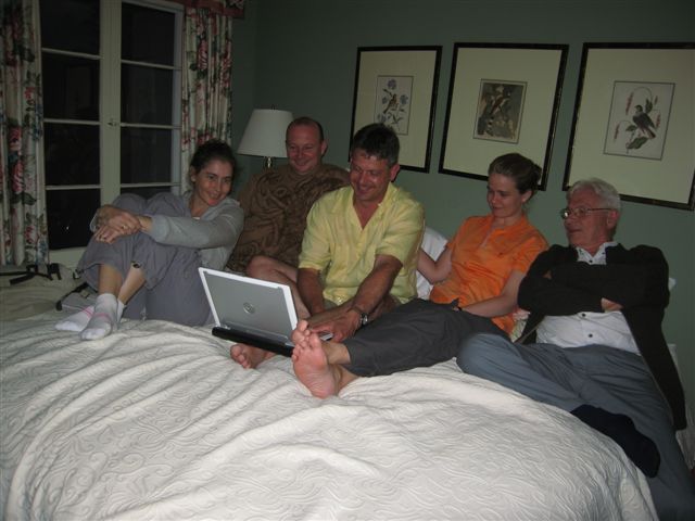 all of the family in one bed looking at today pictures of the wedding