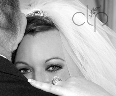 Bride over Dads shoulder