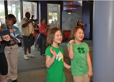 Girls waving at Mickey