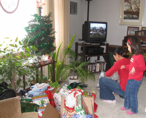 Emilia supervises Mom putting out the presents