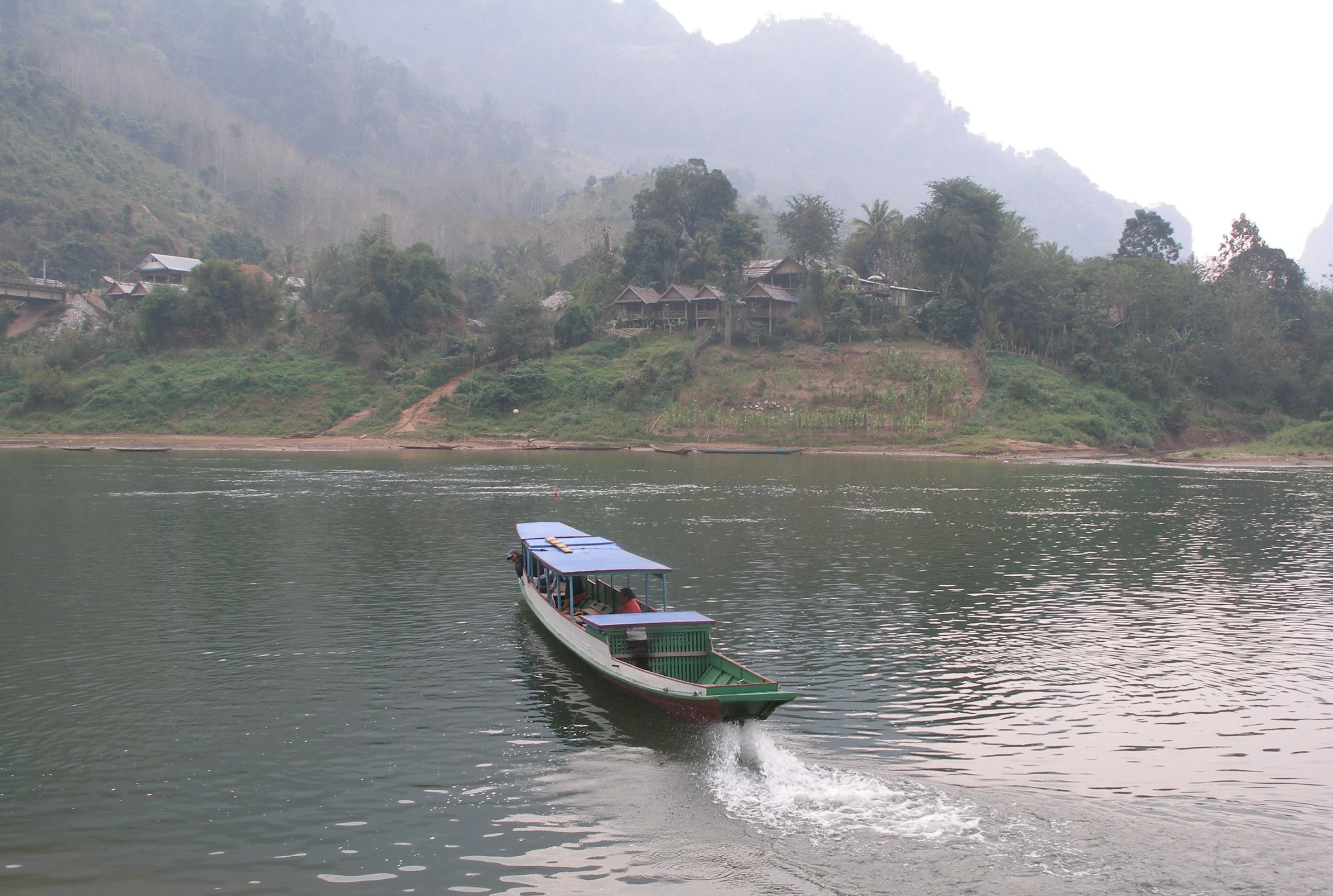Boat crossing Nam Ou; guesthouses on riverbank opposite