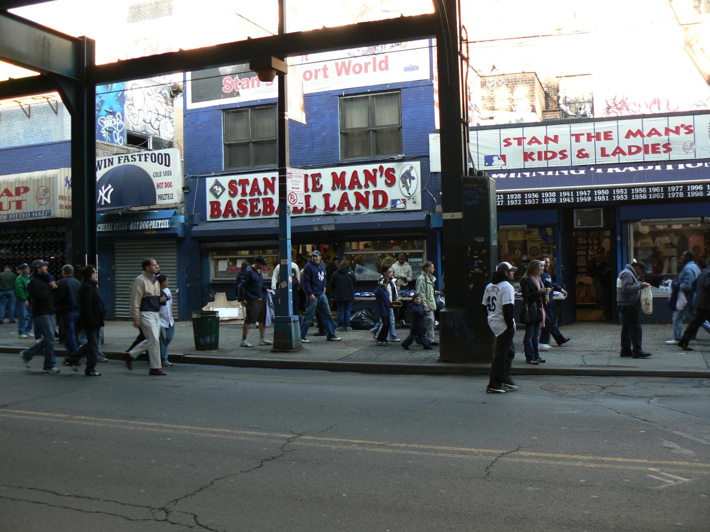 Under the ell looking at the sports shops by Yankee Stadium