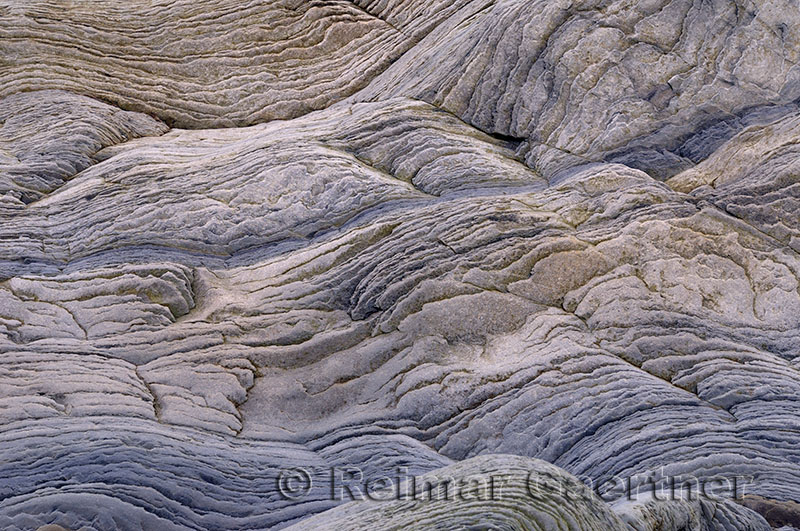 Abstract pattern of wavy sedimentary layers of stone at the Bay of Fundy Cape Enrage