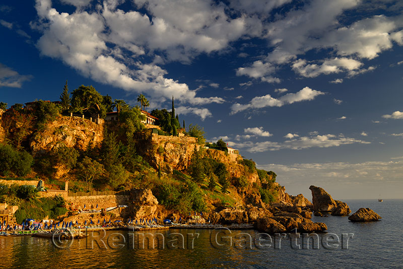 Cliffside resort on Turkish Riviera at Antalya Kaleici Harbour Turkey at sunset