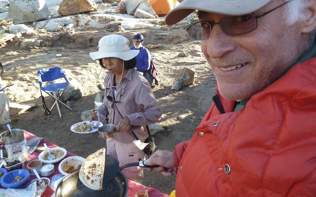 Stan flips his own quesadilla, with Stella and Bob beyond him.