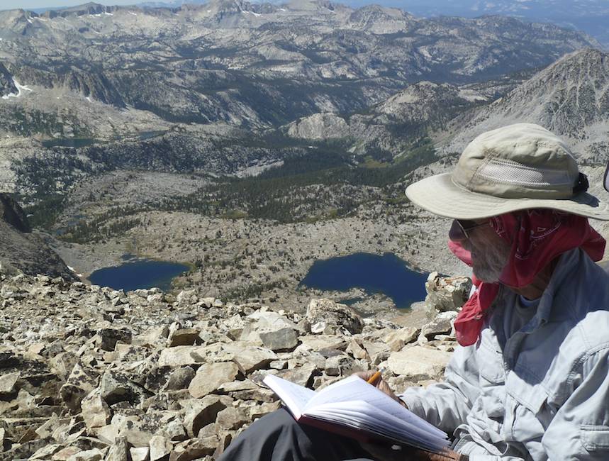 John signs the summit register.