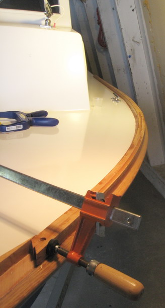 Port rail after gluedown. Screws hold rail in place