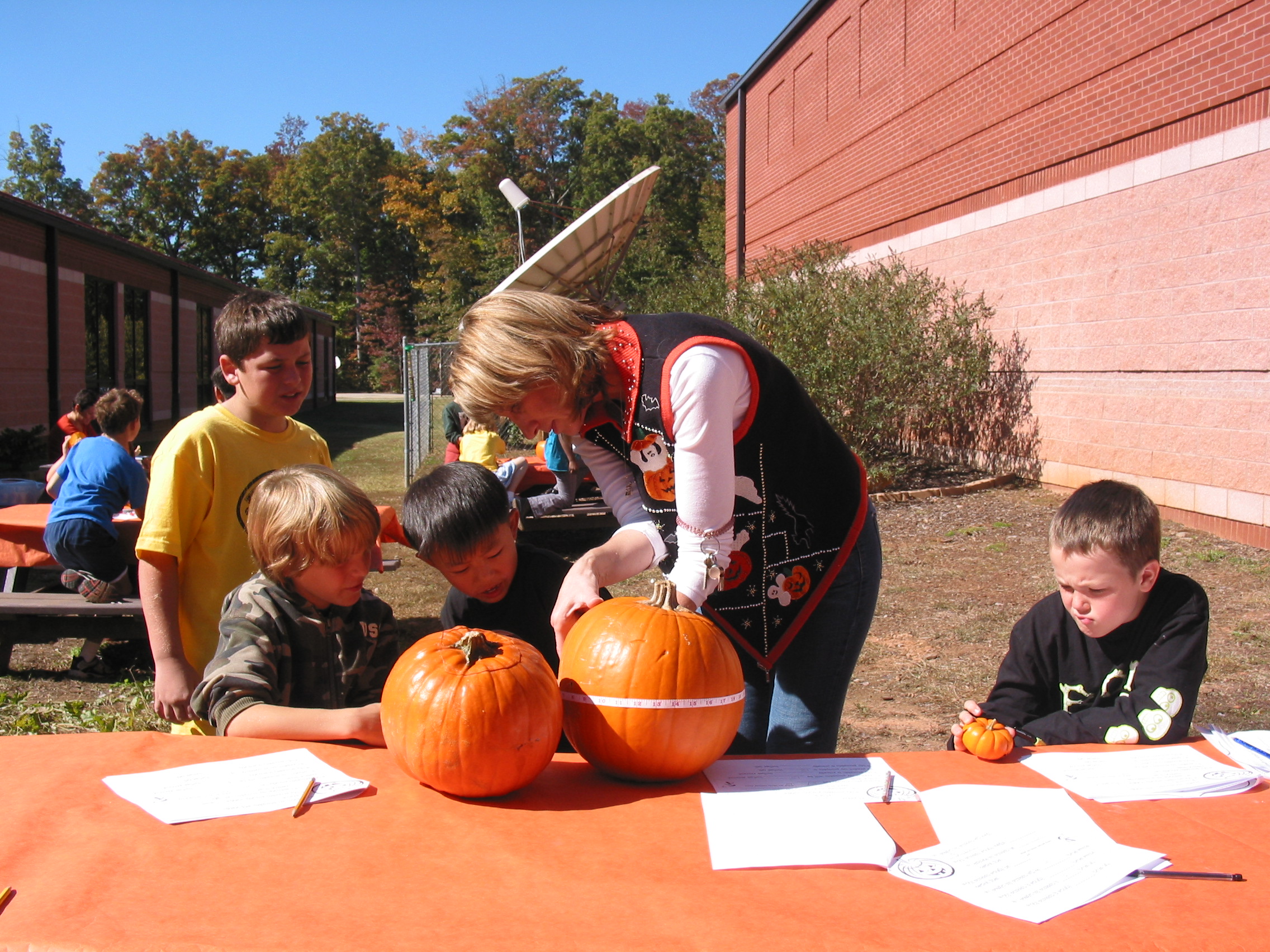 Noah Latzsch, Brent Miller, Nicholas Khou, Ms. Katz, and Timothy Assaf: Measuring pumpkin circumference