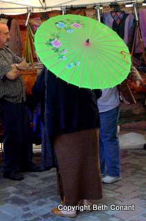 A woman tries out her japanese umbrella.