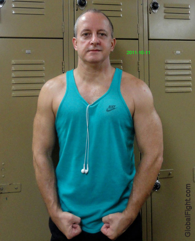 sweaty musclejock posing flexed arms in locker room gym.jpg