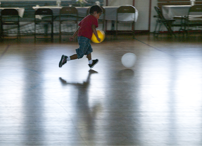 boy chasing white baloon