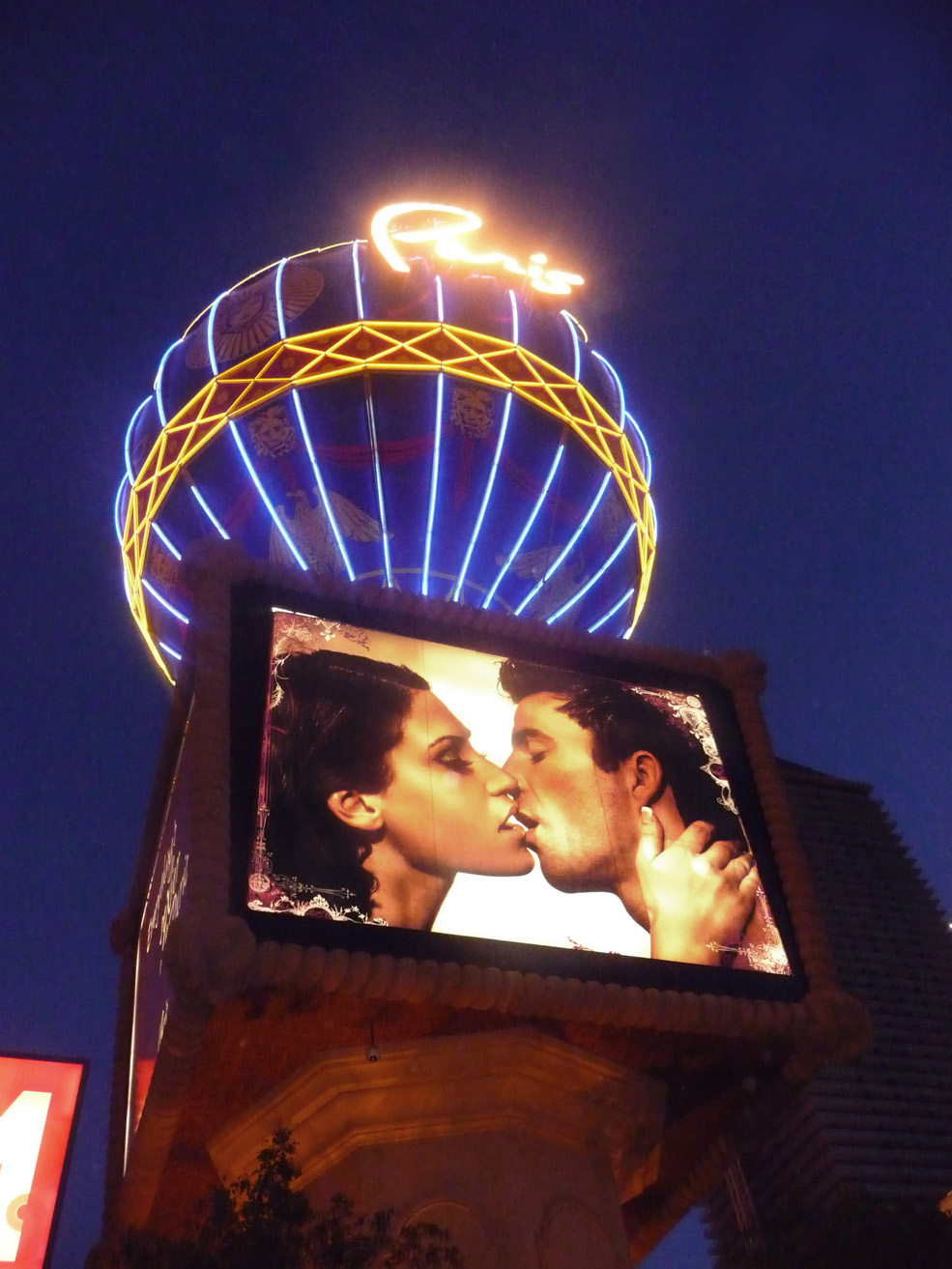 Beneath the balloon is this provocative billboard of a sexy couple kissing.
