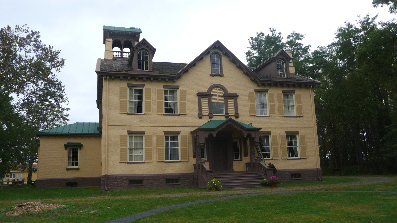 Architect Upjohn painted the brick yellow and brown and added the 4-1/2 story Italianate tower to break up the symmetry.