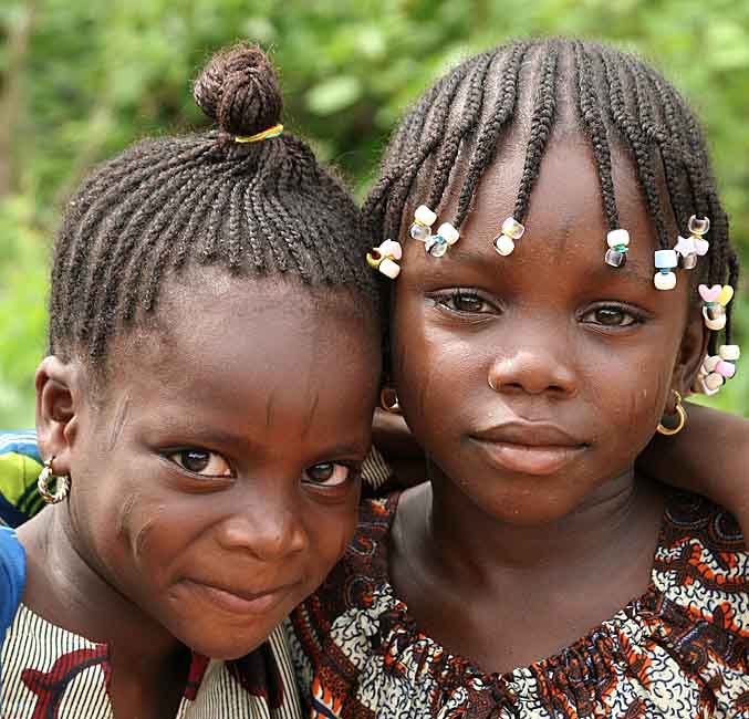 Little sisters in Benin with typical scars in their faces.