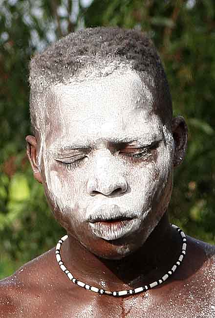 Voodoo. White powder is put in the faces of those in trance.