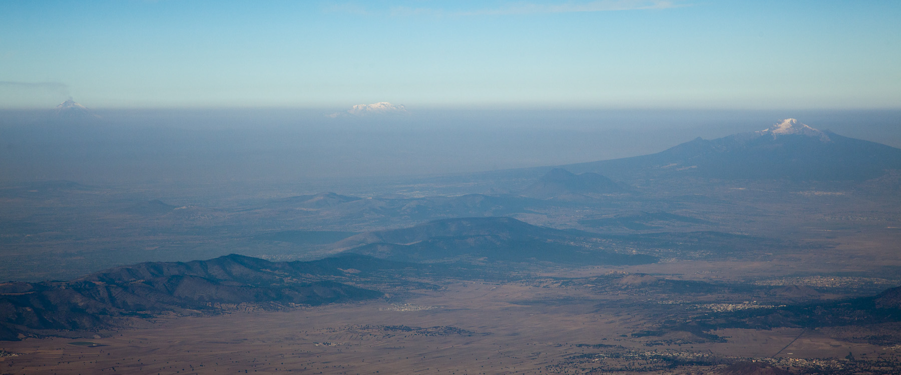 The Volcanoes of Mexico.  From left to right: Popocatepetl (actively erupting), Iztaccihuatl, and Malinche.