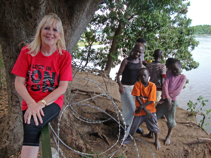 Sitting on the banks of the Nile with the local kids making faces in the background