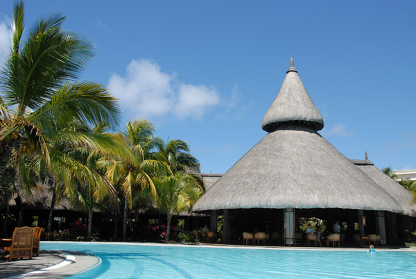 Shandrani Hotel second pool with the thatched roof of one of the restaurants
