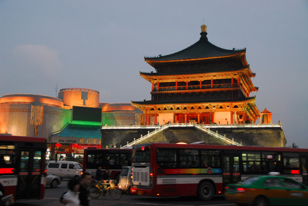 Lights come on at the historic bell tower marking the center of Xi'an