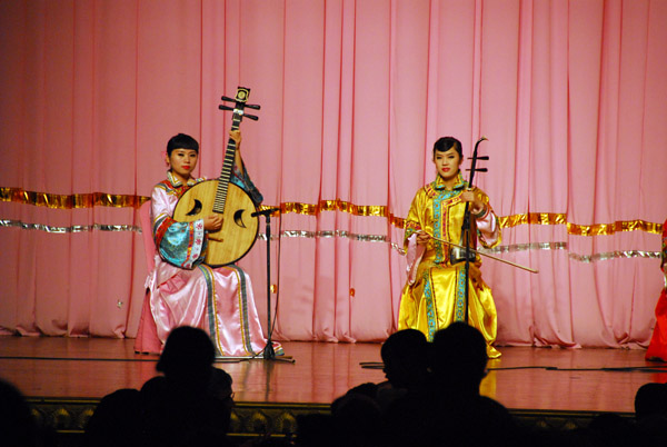 Musicians playing the yueqin (round lute) and erhu (two-stringed fiddle)