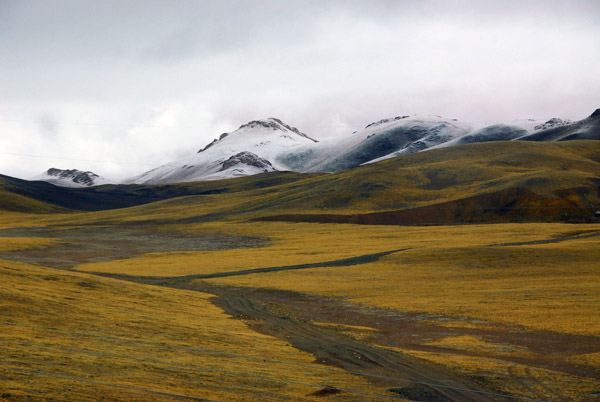 Tibetan plateau with snow covered mountains