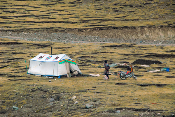 Tibetan tent with a man and a motorbike