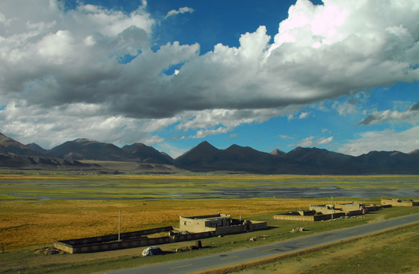 The paved Qinghai-Tibet Highway paralleling the railroad