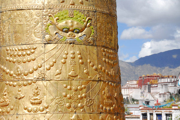 Detail of the bronze roof ornaments of the Jokhang with the Potola in the distance